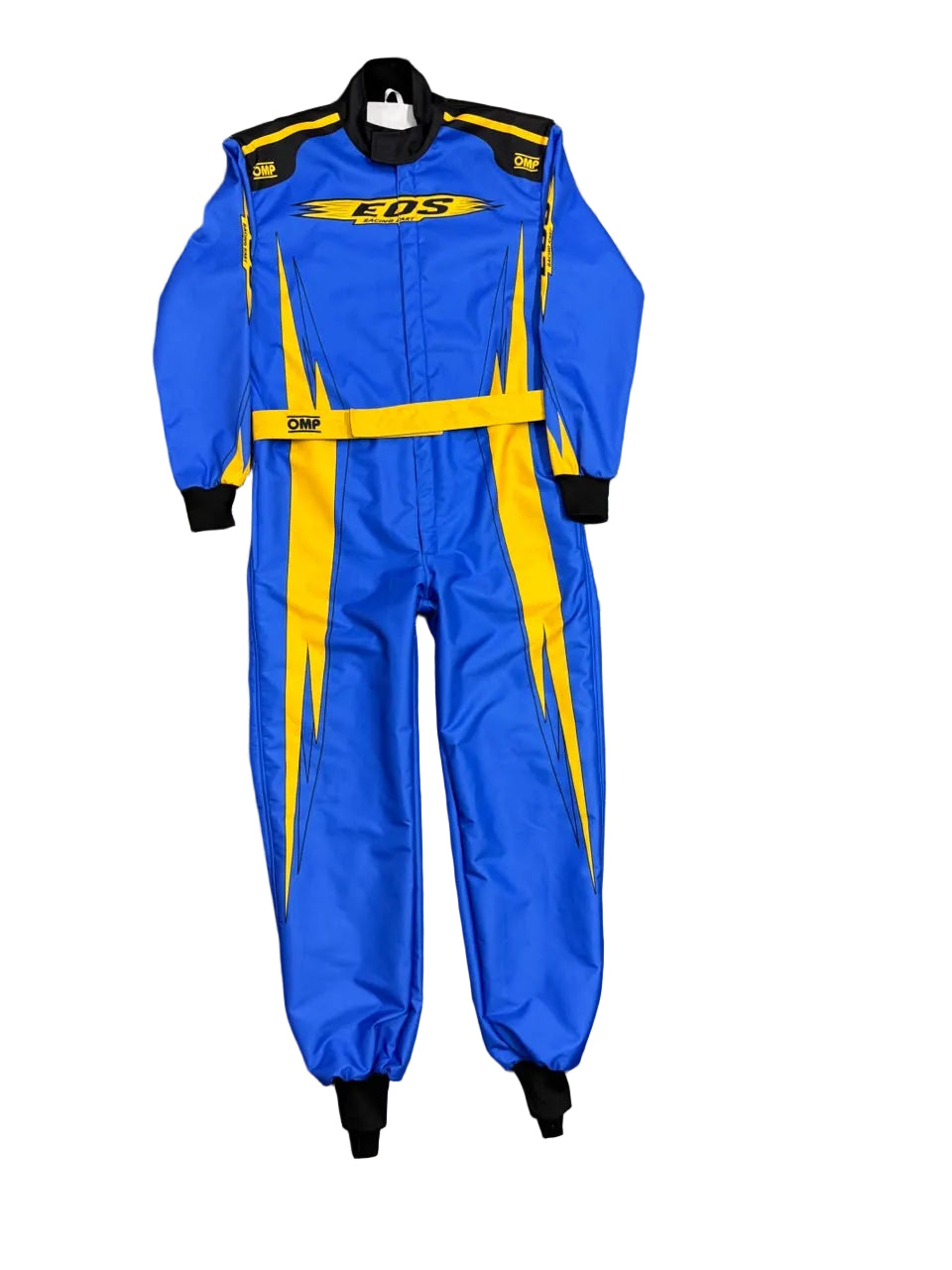 A blue and yellow COS racing suit laid flat on a gray tiled floor. The suit features yellow lightning-bolt style stripes, a yellow chest logo, and black cuffs and collar.