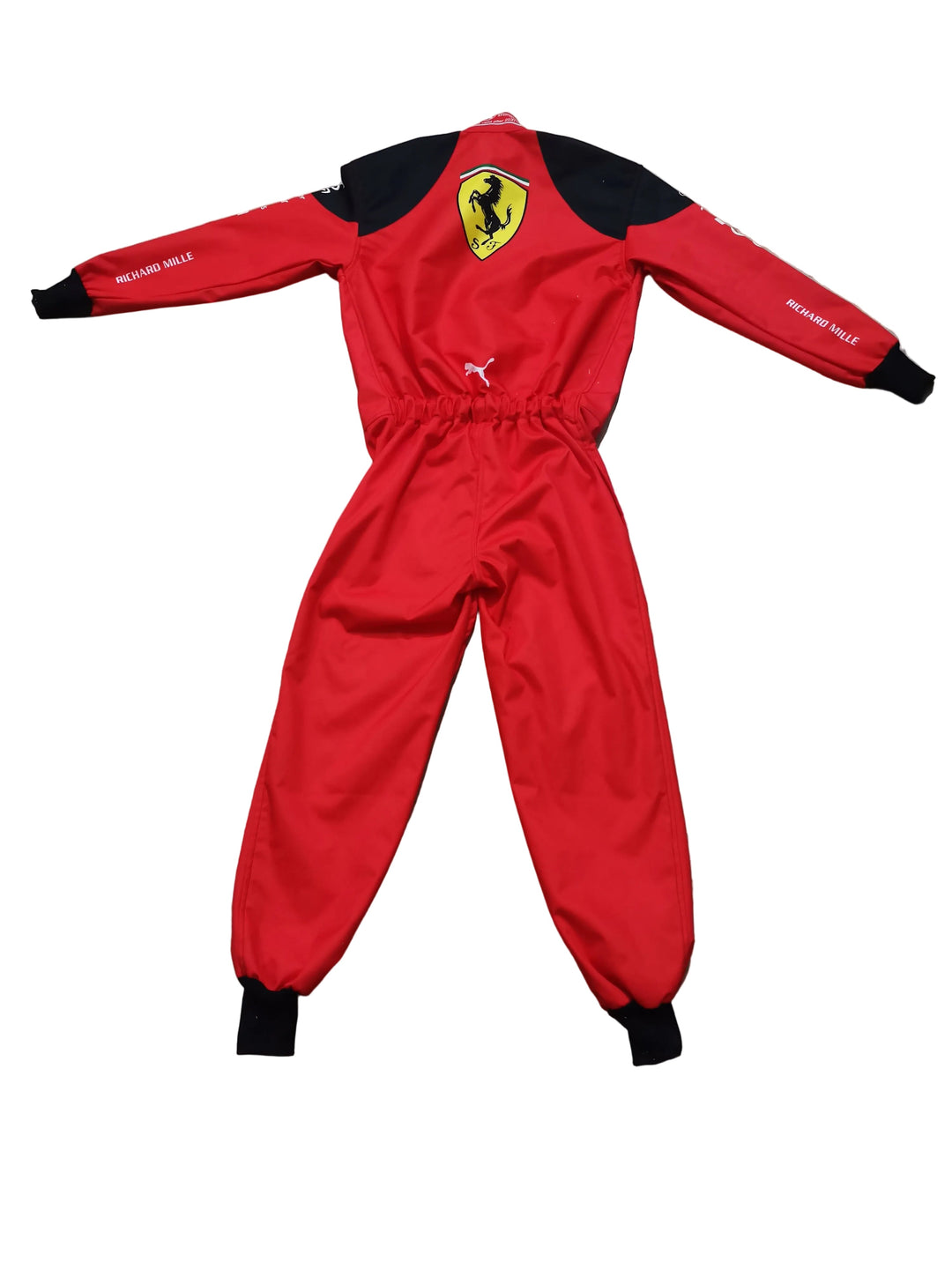 A red and black long-sleeve one-piece jumpsuit with Ferrari branding, laid flat on a beige marble floor.