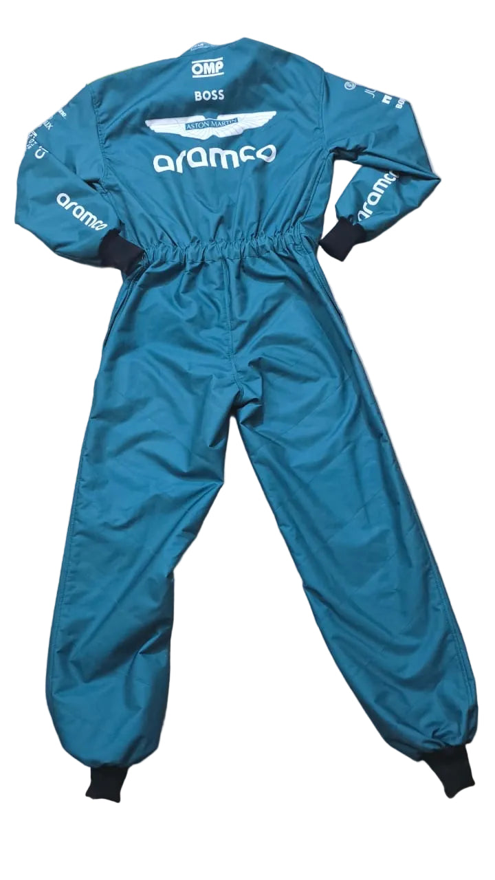 A teal blue racing jumpsuit with black cuffs and ankles, laid flat on a beige marble floor. The jumpsuit features white sponsor logos including 'aramco' and 'OMP'.