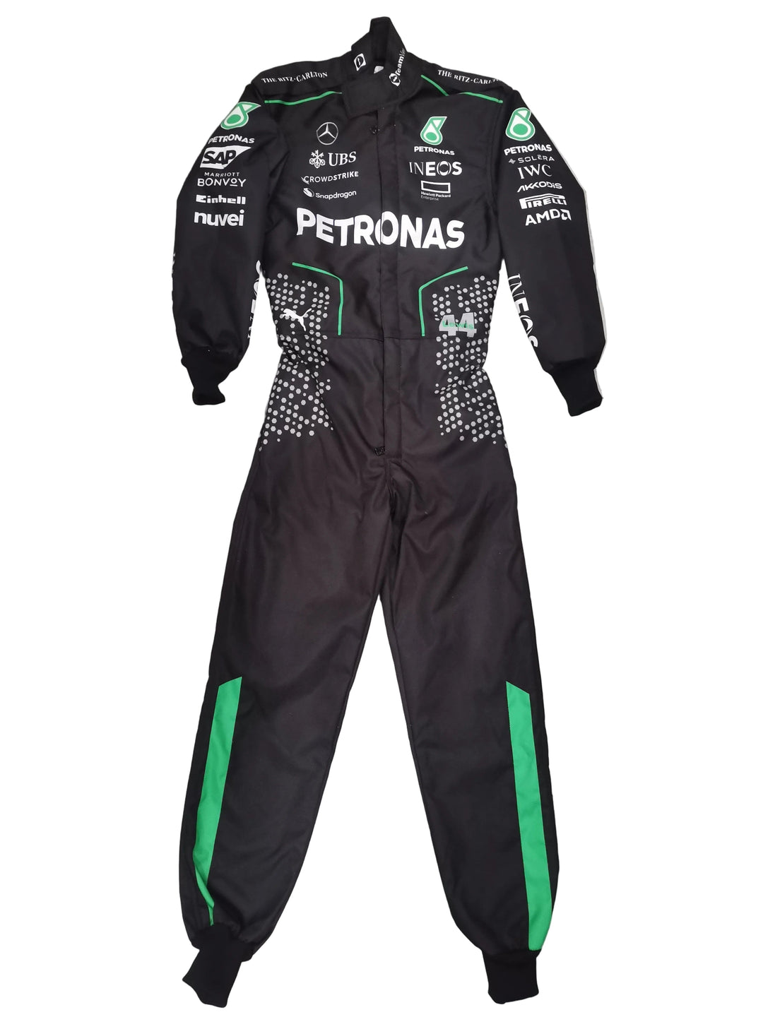 A black Mercedes Petronas racing suit with green accents and various sponsor logos, laid flat on a gray marble tile floor.