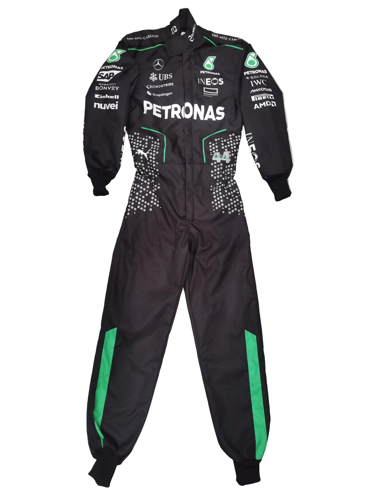 A black Mercedes Petronas racing suit with green accents and various sponsor logos, laid flat on a gray marble tile floor.