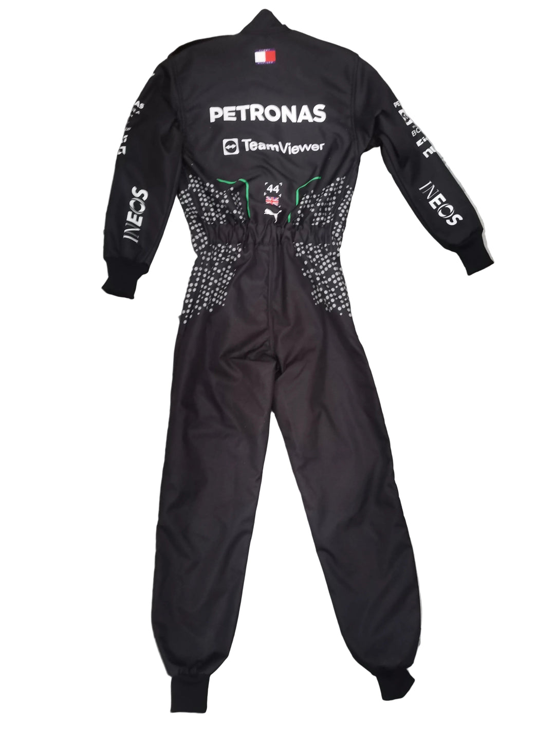 A black Petronas Team F1wear one-piece racing suit with white sponsor logos and silver rhinestone embellishments on the sides, laid flat on a gray marble tiled floor.