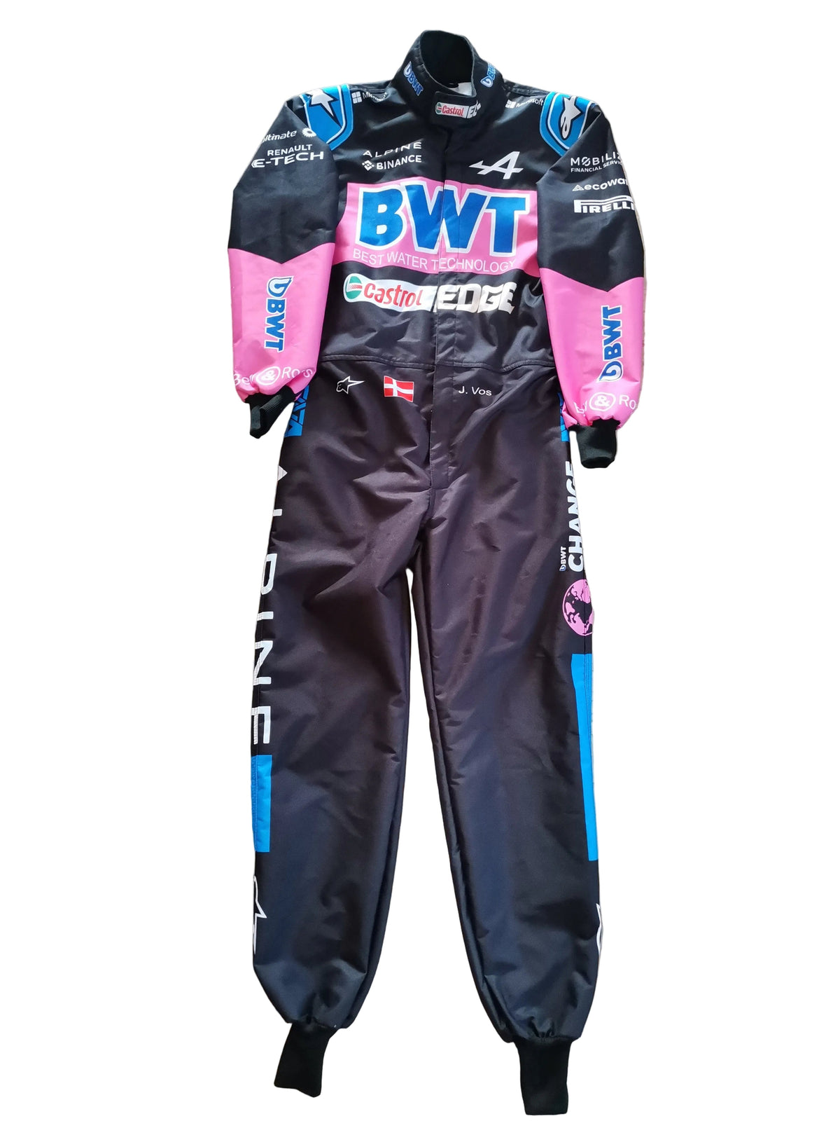 A full-body racing suit laid flat on a beige marble floor. The suit is primarily black with bright pink sleeves and side panels, blue accents, and multiple sponsor logos including BWT, Castore, and Daimler.