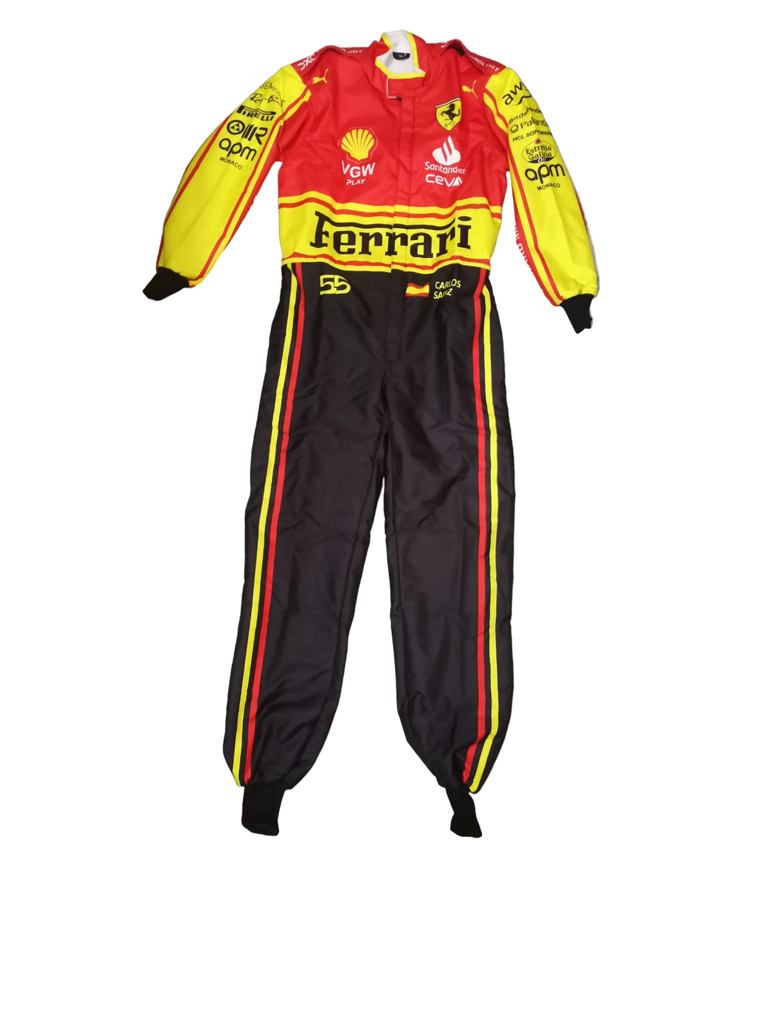 A Ferrari racing suit laid flat on a gray marble-patterned floor. The one-piece tracksuit features a red and yellow top with 'Ferrari' and sponsor logos, paired with black pants that have red and yellow side stripes.