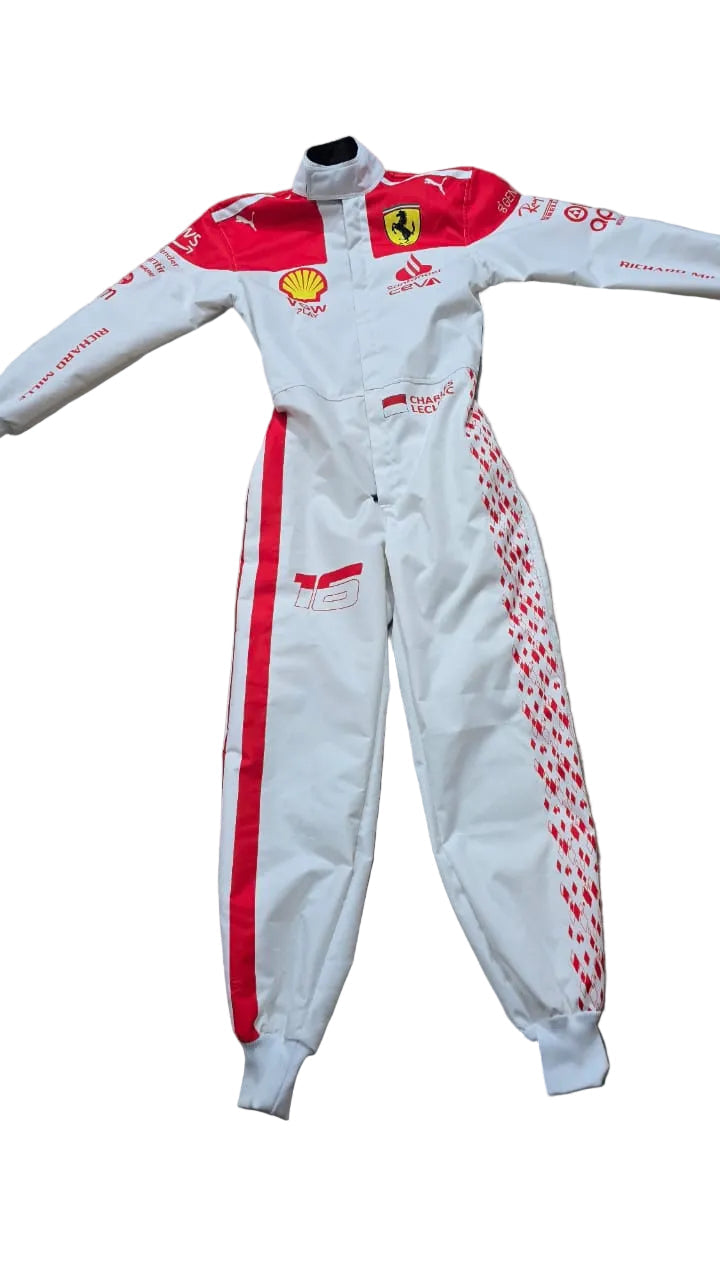 A white and red Scuderia Ferrari racing one-piece suit with Shell and Ferrari logos, laid flat on a beige tiled floor.