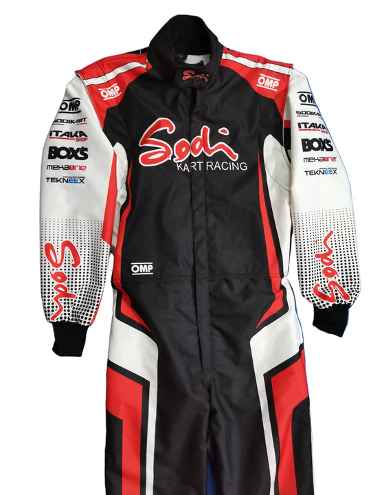 A black, white, and red Sodi Kart Racing full-face racing suit laid flat on a blue background. The suit features various sponsor logos including OMP, Boxs, FreshGrip, and Tekshinx.