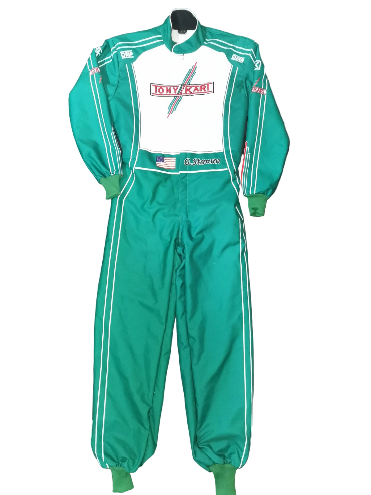 A green and white racing suit laid flat on a black fabric background, featuring a white chest panel with a red and blue 'Tony Kawasaki' logo, green cuffs and leg openings, and white side stripes.