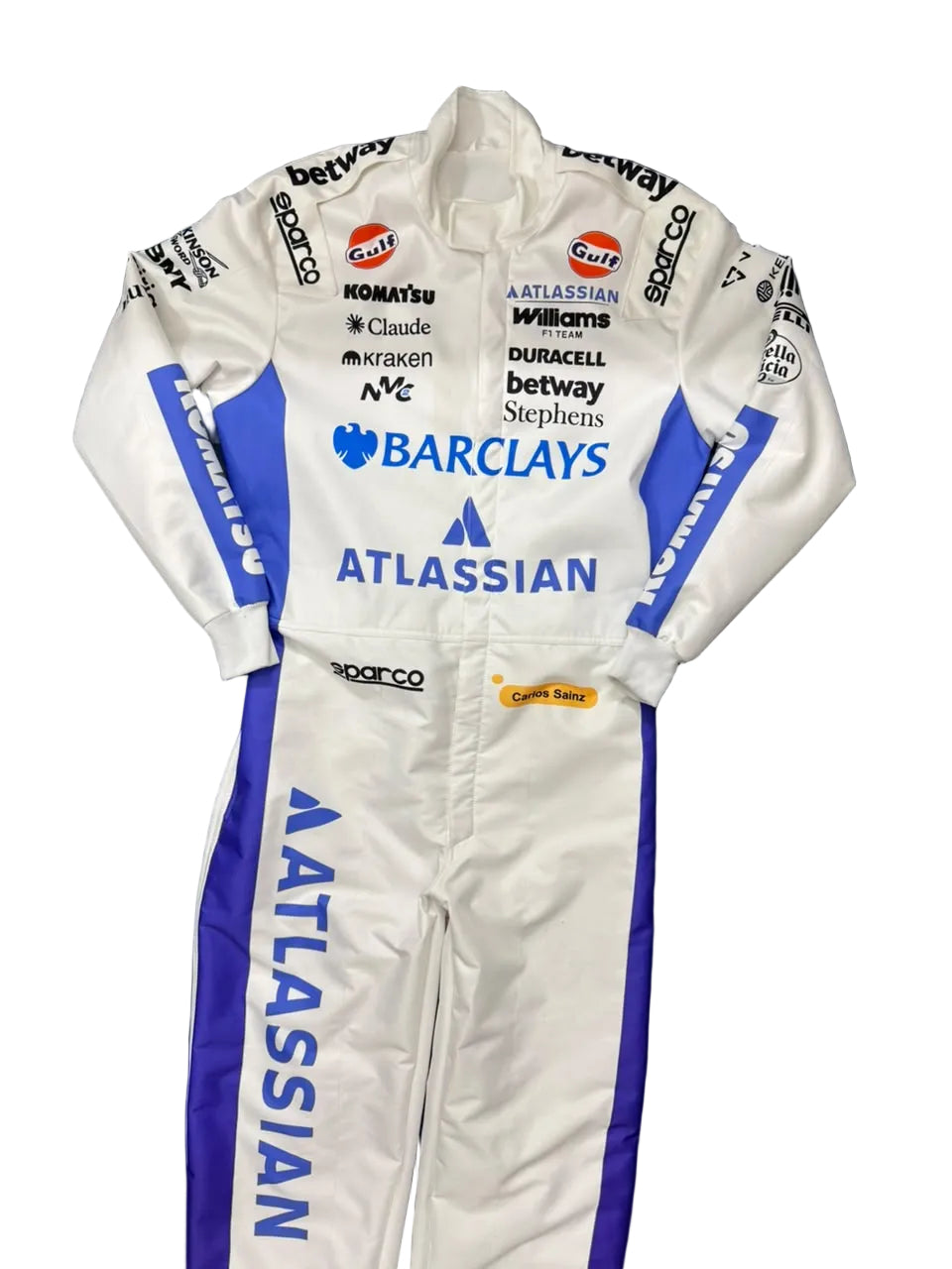 A white and blue racing suit with multiple sponsor logos, including Barclays, ATLASSIAN, and Sparco, laid flat on a dark blue blanket.