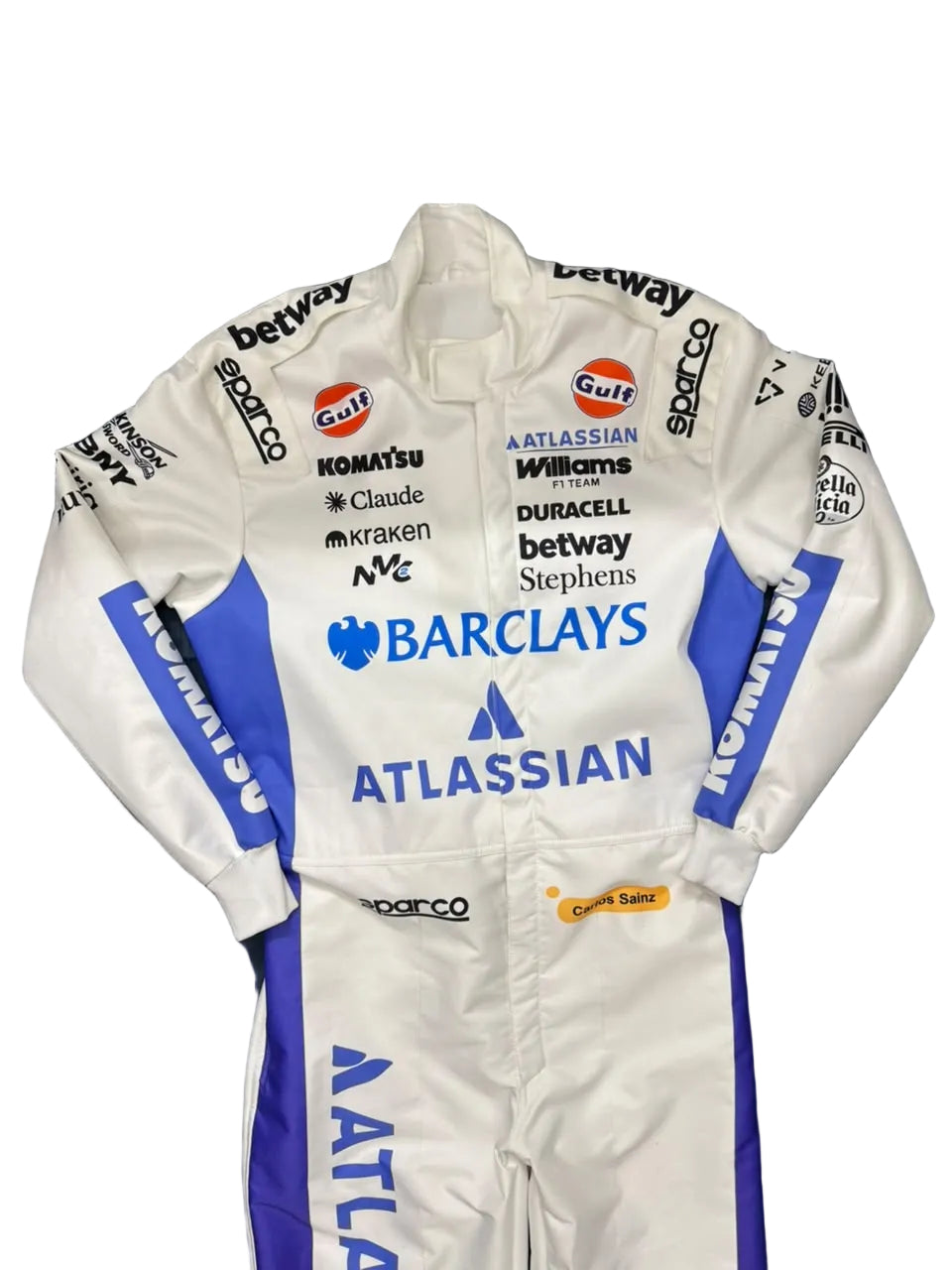 A white and blue racing suit with multiple sponsor logos, laid flat on a dark blue fabric surface.