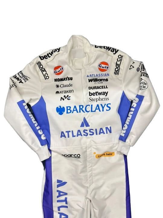 A white and blue racing suit with multiple sponsor logos, laid flat on a dark blue fabric surface.