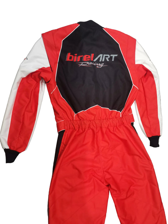 A red, black, and white BirelArt Racing one-piece racing suit laid flat on a gray marble-patterned floor, showing the back view with the brand logo.