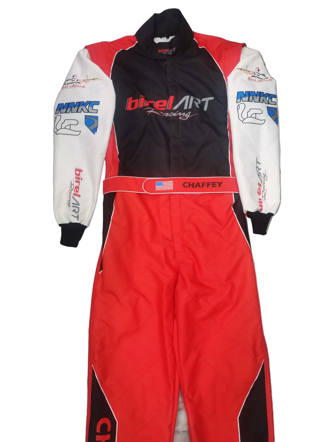 A red, black, and white full-face racing suit with sponsor logos, laid flat on a gray tiled floor. The suit features 'birElArt Racing' on the chest and 'CHAFFEY' on the waistband.