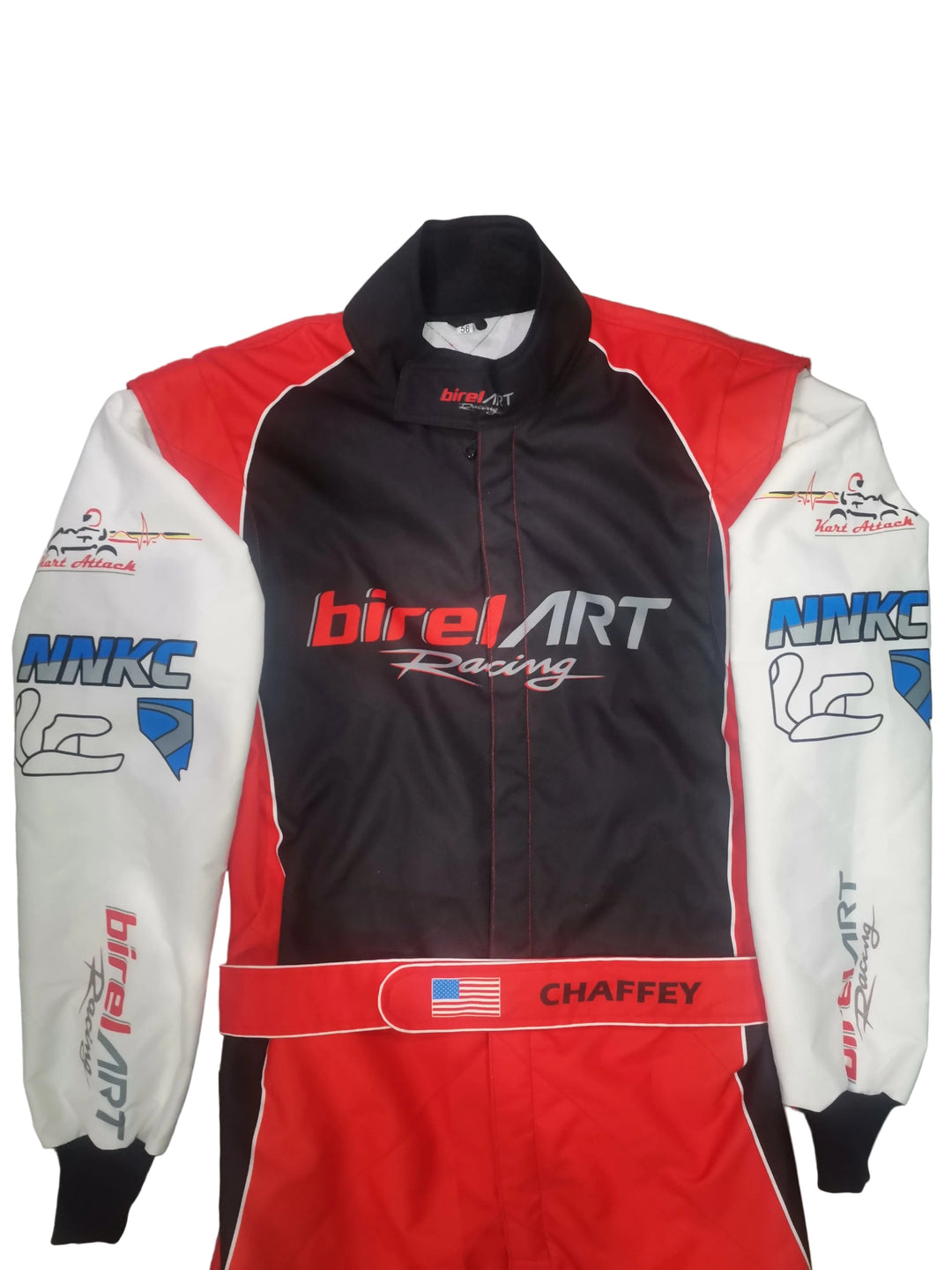 A full-body racing suit laid flat on a gray tiled floor. The suit is primarily black on the torso, with red side panels and white sleeves.
