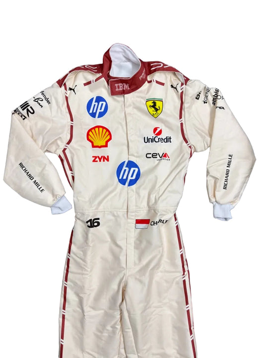 A cream-colored Scuderia Ferrari racing suit by Richard Mille, featuring multiple sponsor logos including HP, Shell, and Unipred, laid flat on a dark blue blanket.