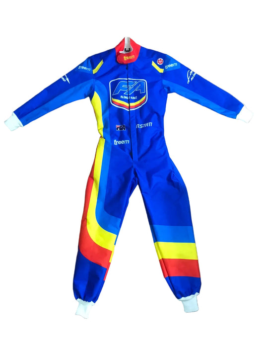 A blue one-piece racing suit laid flat on a wooden floor, featuring red, yellow, and white graphic panels on the legs and sleeves, with various sponsor logos including Castore, BFG, and Telemart.