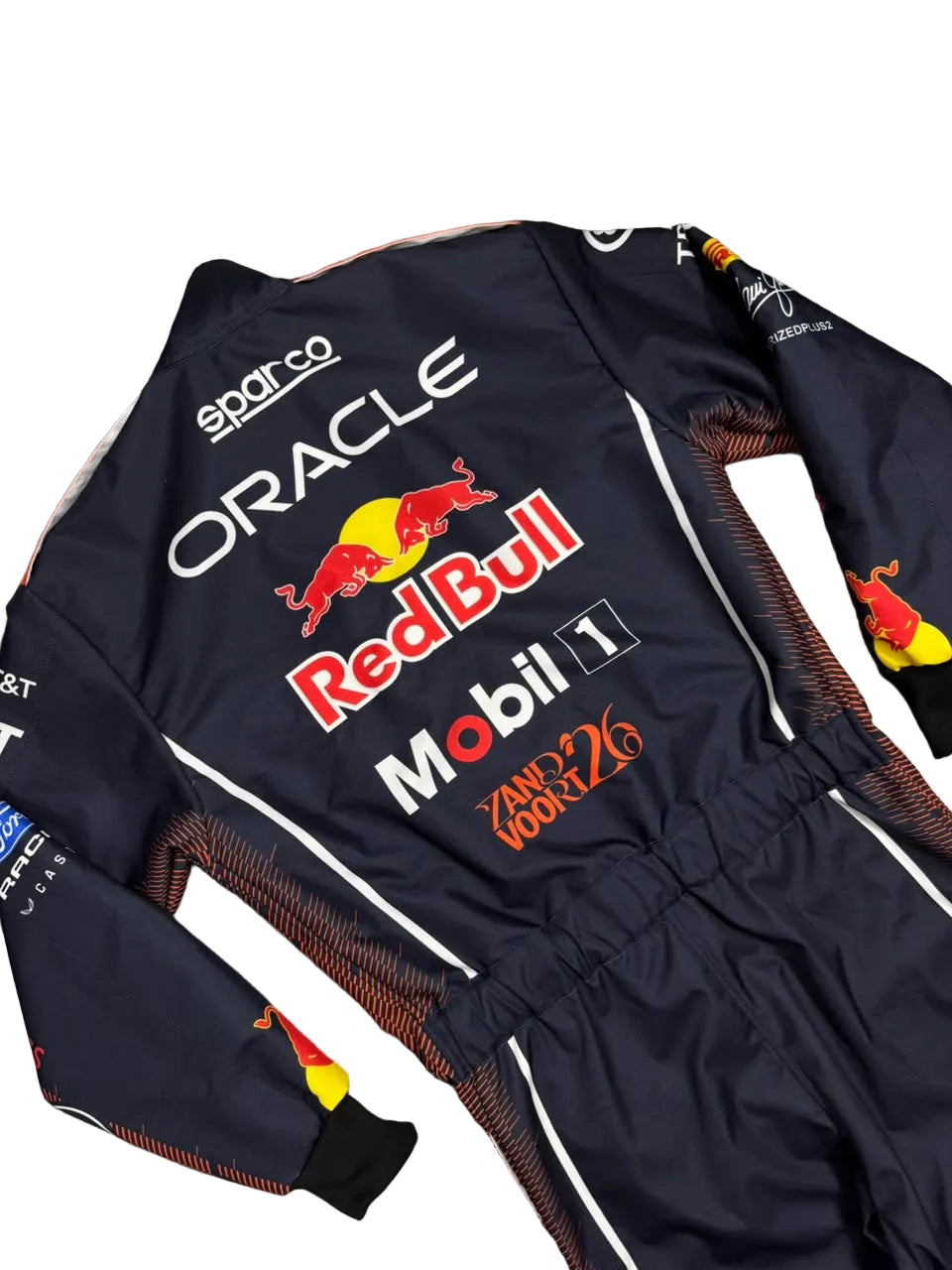 A dark navy Red Bull Racing team jumpsuit with sponsor logos including Red Bull, Mobil 1, Oracle, and SAP, laid flat on a gray tiled floor.