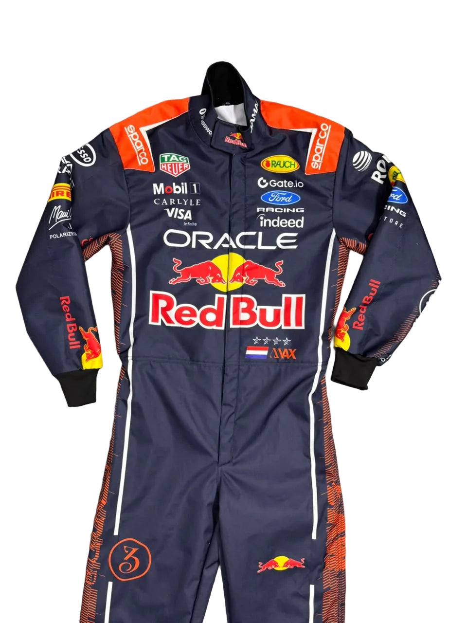 A Red Bull Racing team one-piece racing suit laid flat on a gray tiled floor. The suit is navy blue with orange and white accents, featuring prominent sponsor logos including Oracle, Red Bull, Castore, Mobil 1, and Ford.